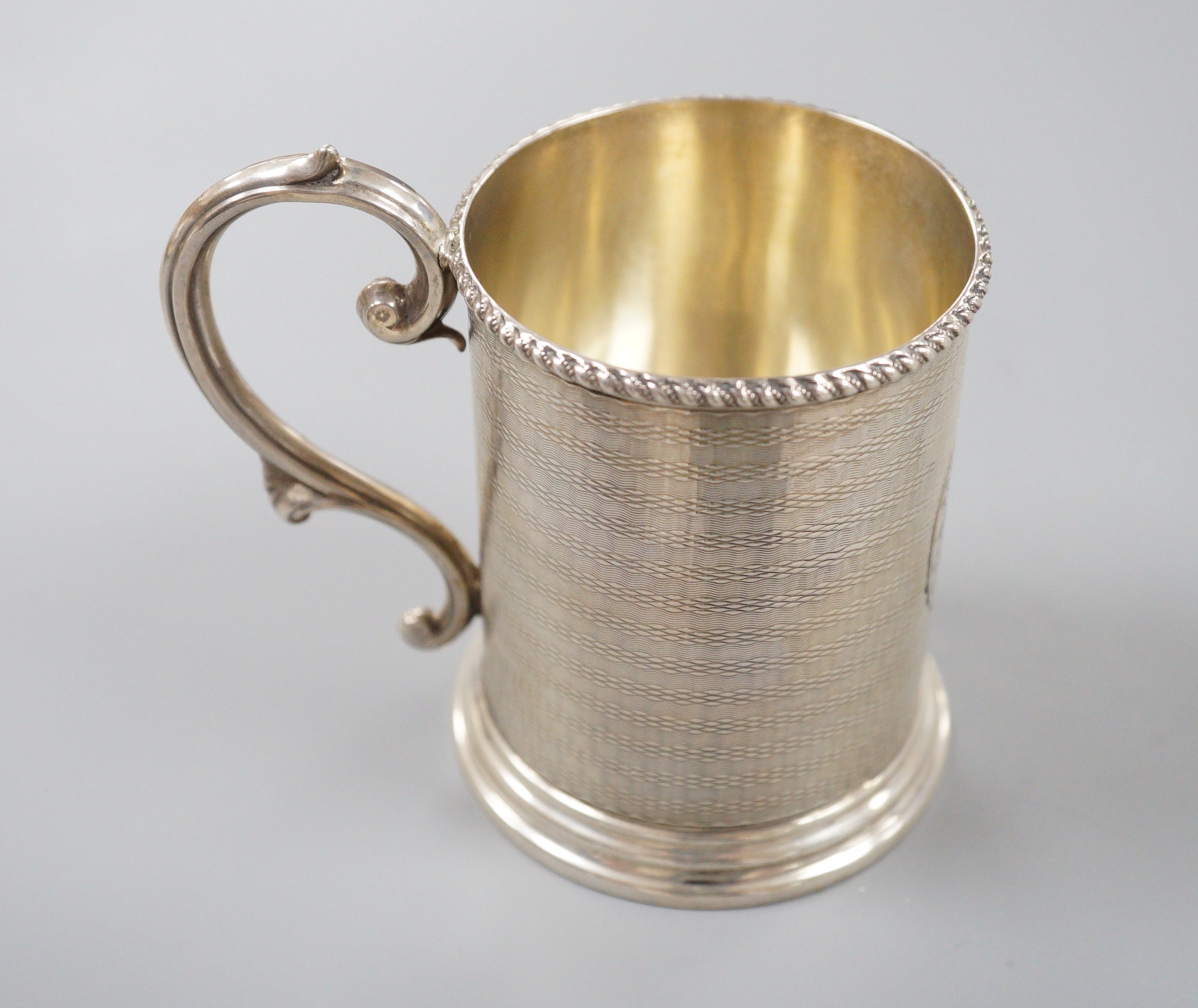 A Victorian engine turned silver christening mug, with engraved inscription, George Unite, Birmingham, 1868, 86mm.